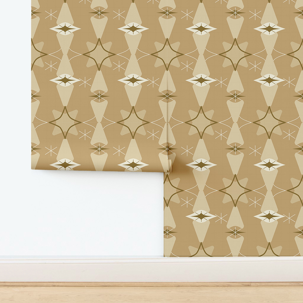The artwork features a repeating geometric pattern of symmetrical shapes resembling elongated, curved diamonds or petals in various shades of blue and green. Each shape is split vertically with one half filled with a light blue and the other half filled with green or darker blue. The background is a light, almost pastel blue, which provides a soft yet vibrant backdrop. One of the blue shapes near the upper left contains a white starburst element, adding a focal point of brightness to the composition. The overall design conveys a modern, mid-century aesthetic with clean lines and harmonious color contrasts.